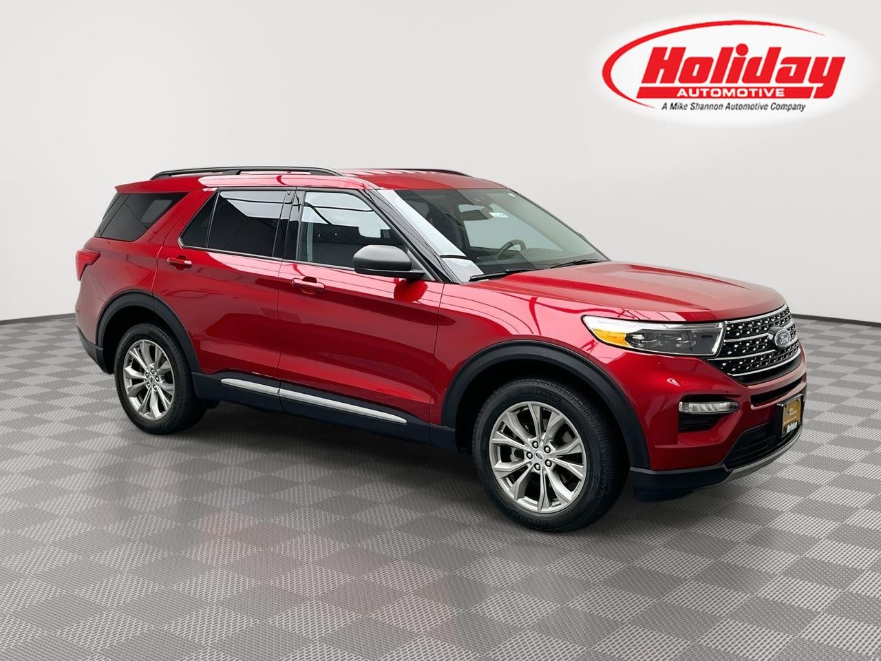 2023 Ford Explorer XLT in Rapid Red Metallic Tinted Clearcoat — front three-quarter view