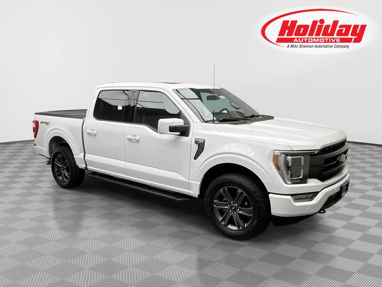 2023 Ford F-150 LARIAT in Oxford White — front three-quarter view