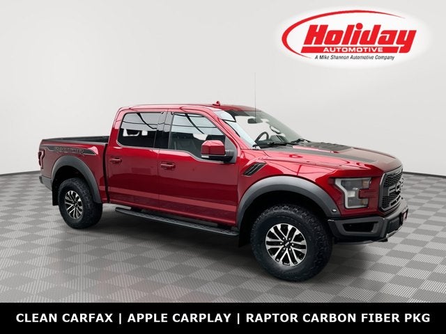 2019 Ford F-150 Raptor in Ruby Red Metallic Tinted Clearcoat — front three-quarter view